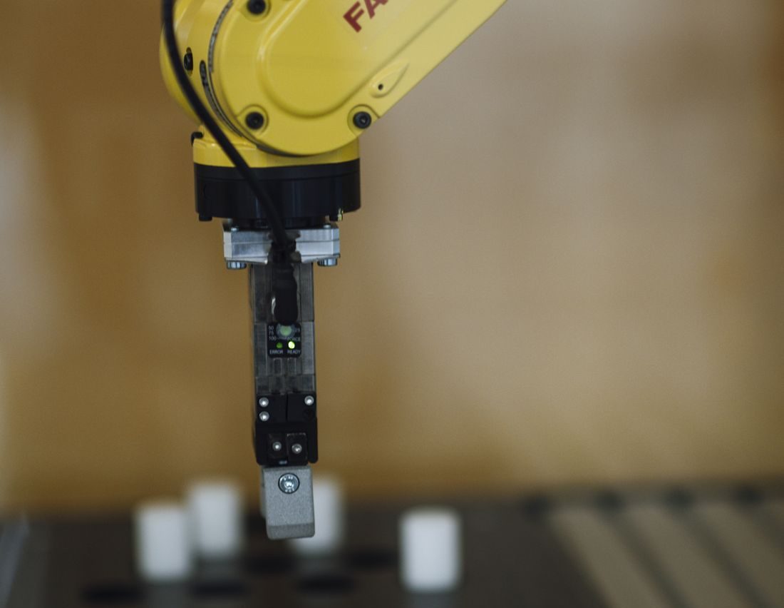 An industrial robotic arm representing automated, repeatable business processes