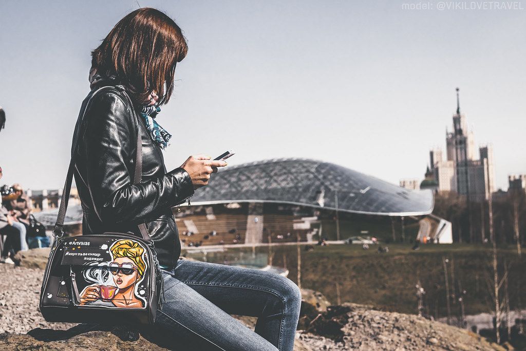 A woman using WhatsApp on her smartphone